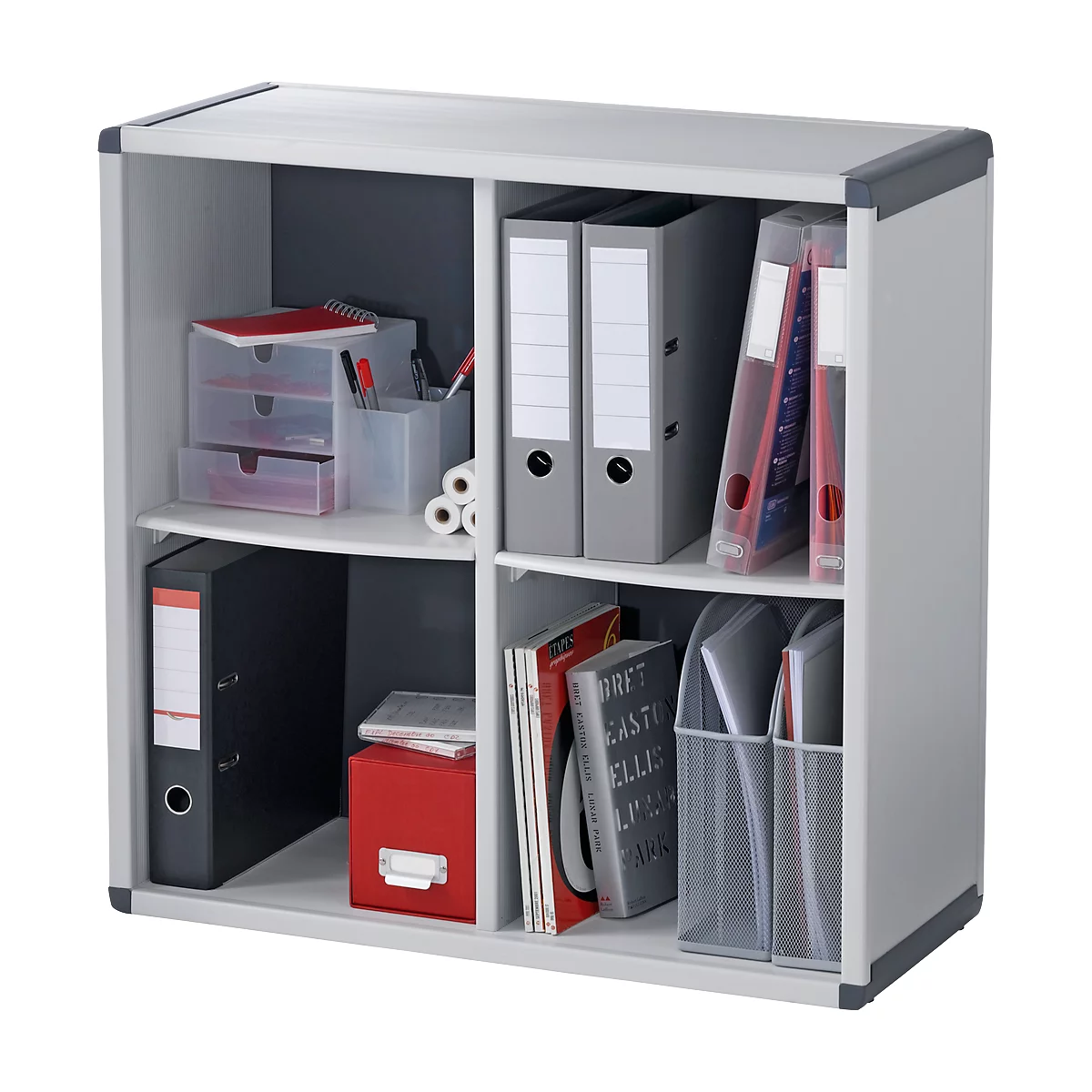 A white shelf with four compartments filled with binders, books, and office supplies.