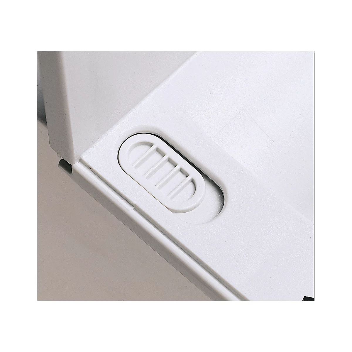 Detail of white plastic featuring an oval recessed element containing a slider with three horizontal bars.