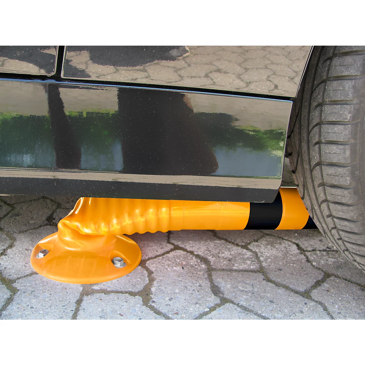 Yellow parking protection under black car, view of wheel and side of vehicle. The protection is deformed, the tire touches it.