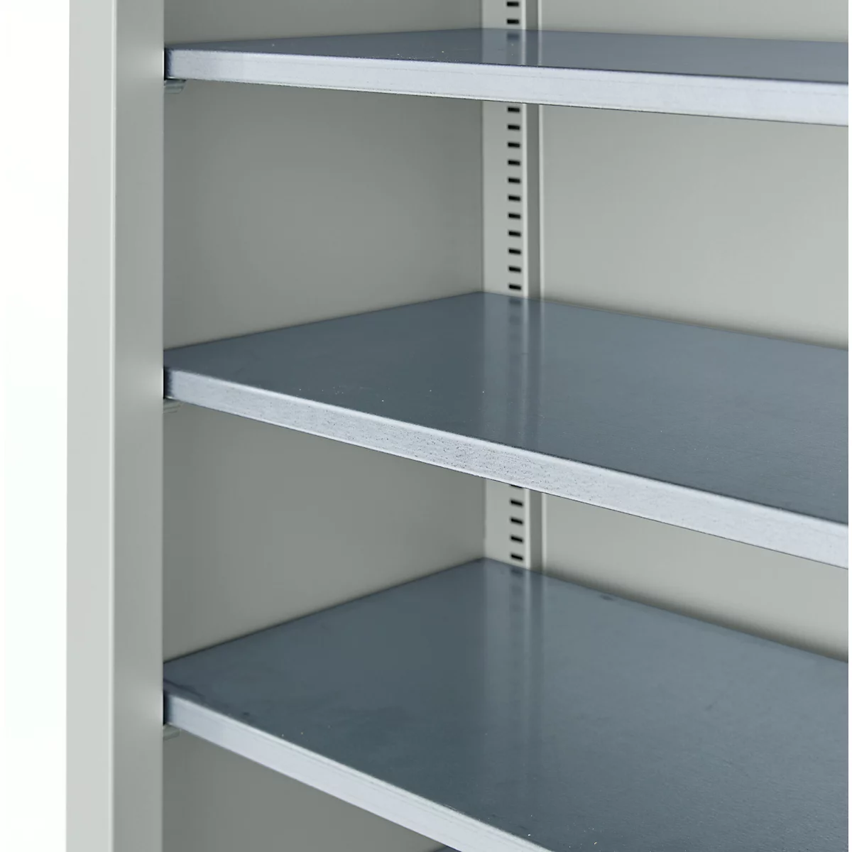 Innenansicht eines grauen Schranks mit drei Fachböden. Die Regale sind aus Metall, der Schrank selbst hellgrau.