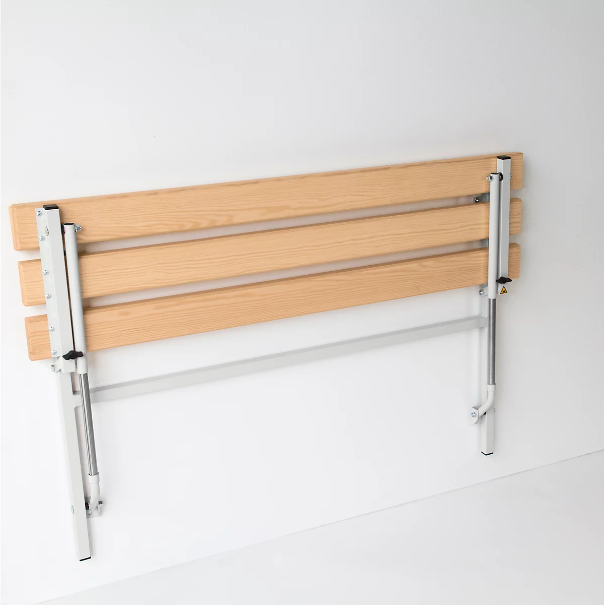 Folding shower bench made of wood and metal, mounted on a white wall.