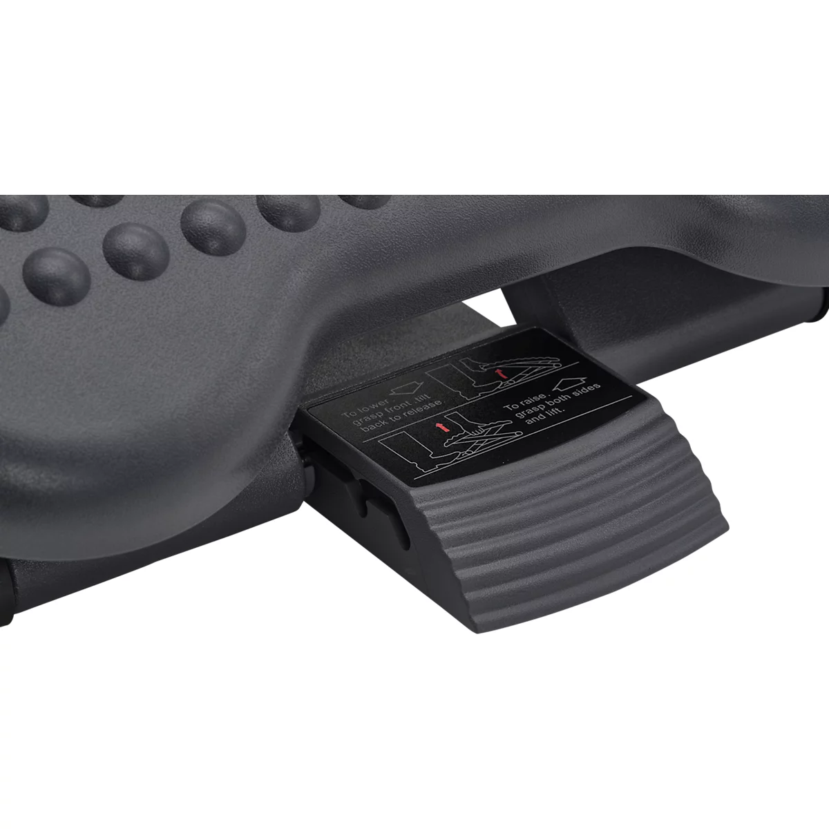 Close-up of a black footrest mechanism. Instructions are pictured on a panel.