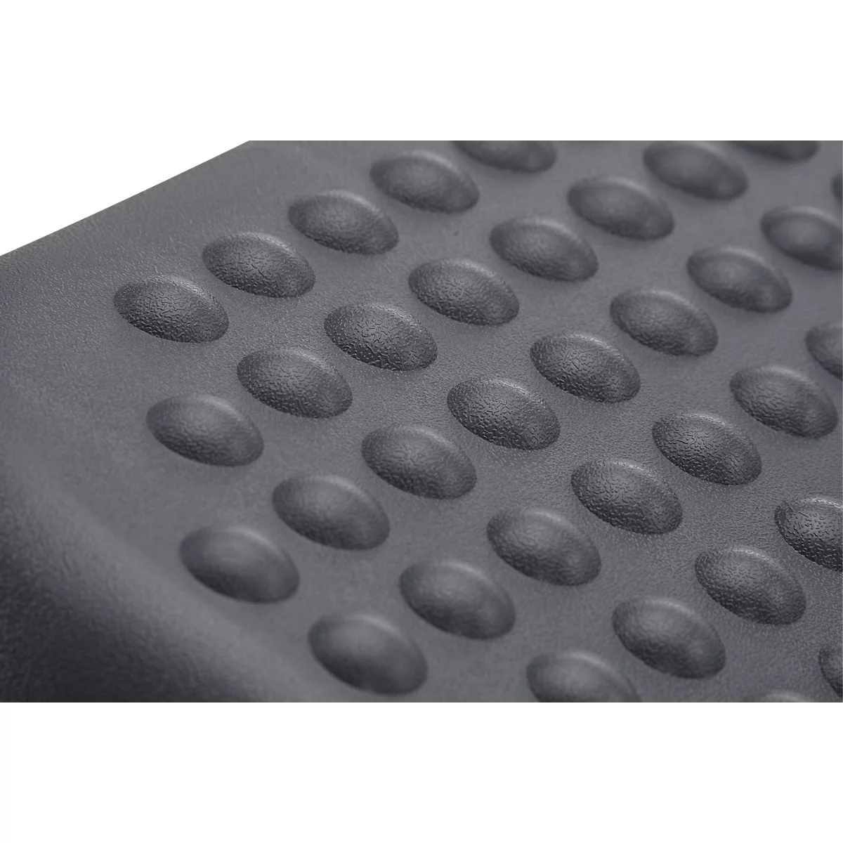Gray surface with raised, oval studs.