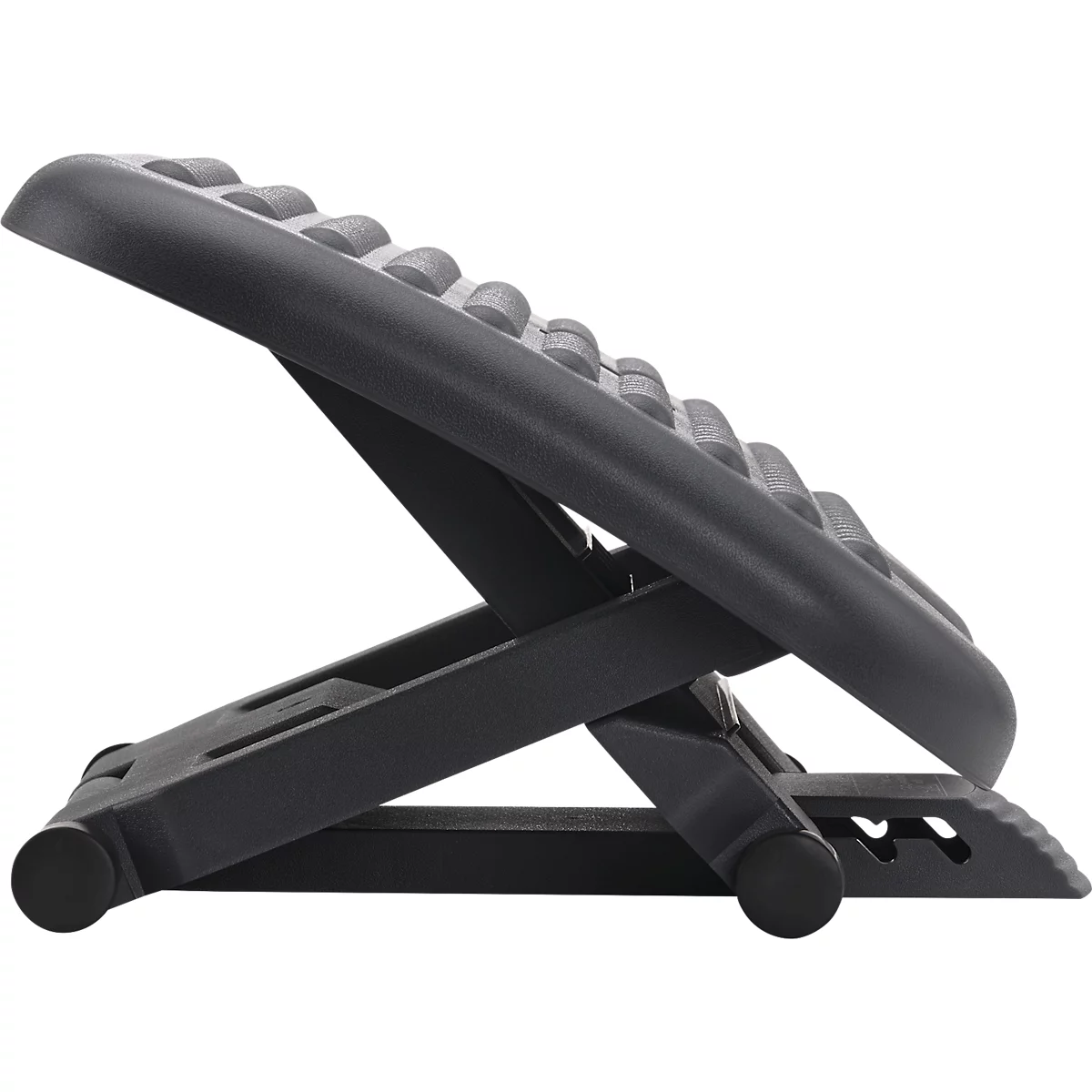 Black footrest with a textured surface and an adjustable frame.