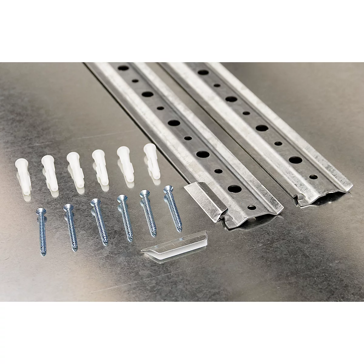 Two metal rails with screws, dowels, and clips on a silver background.