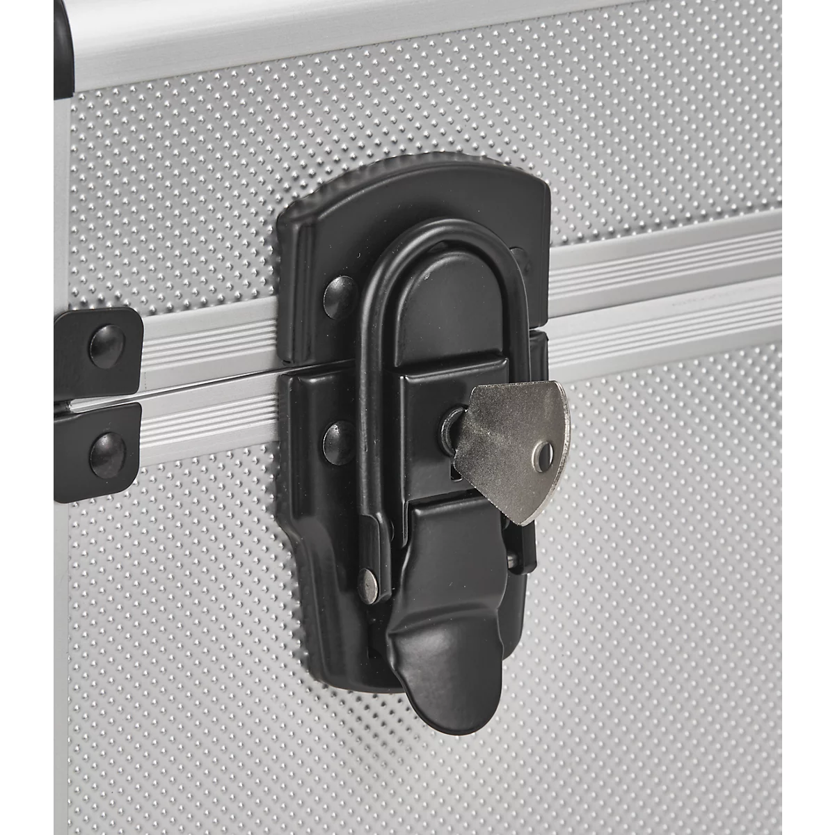 Close-up of a silver suitcase with a black clasp and a key.