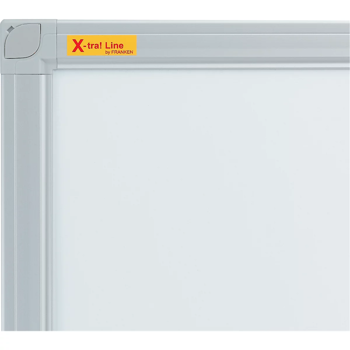Detail shot of a white board with a gray frame. Upper right yellow sign with red text: X-tra! Line.