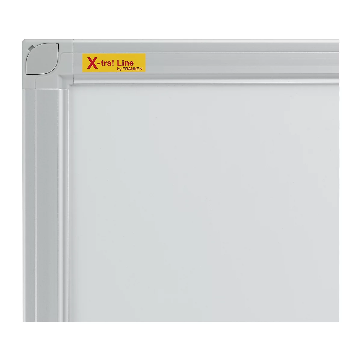 Section of a white board with a silver frame. A corner is visible in the upper left. A yellow sticker reads "X-tra! Line by FRANKEN".