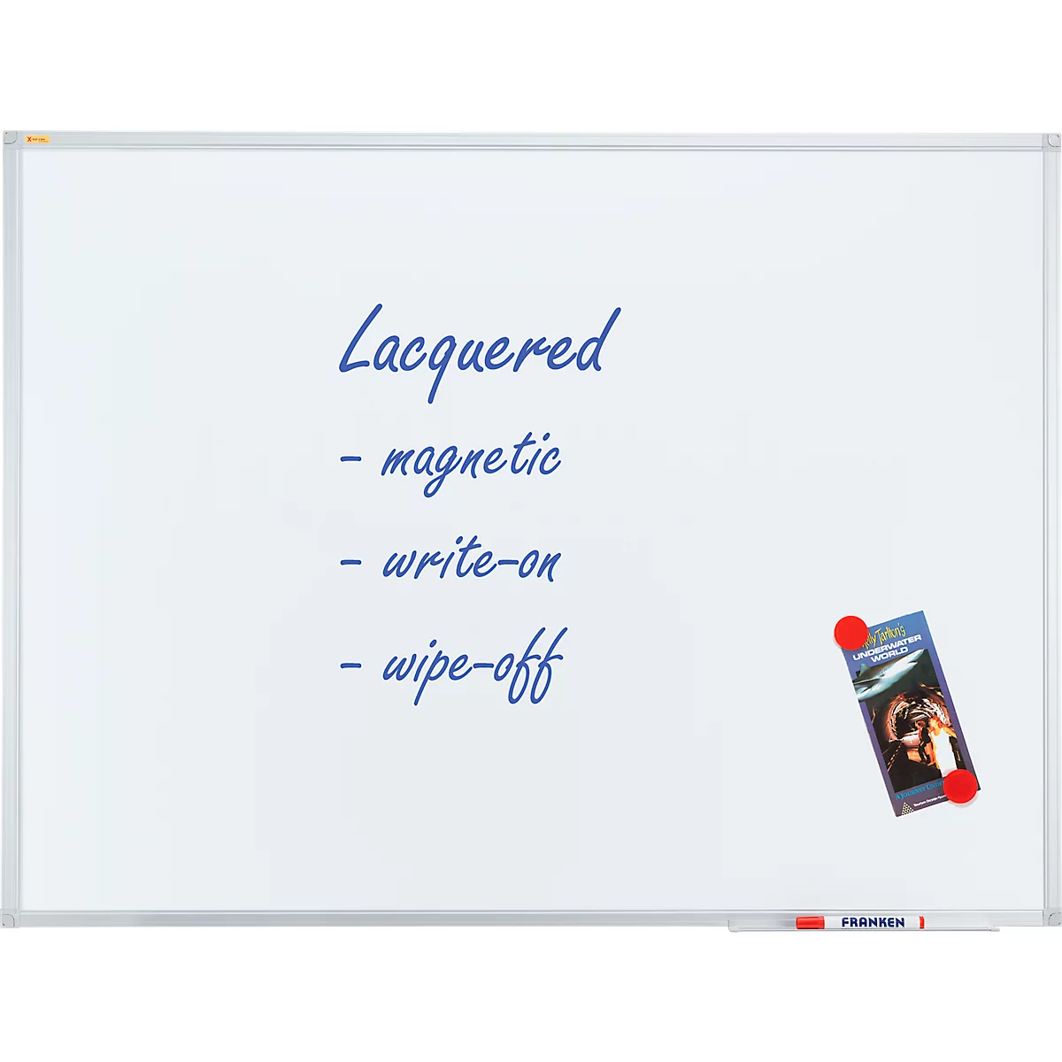 White whiteboard with blue text: 'Lacquered - magnetic - write-on - wipe-off'. A magnet holds a brochure.