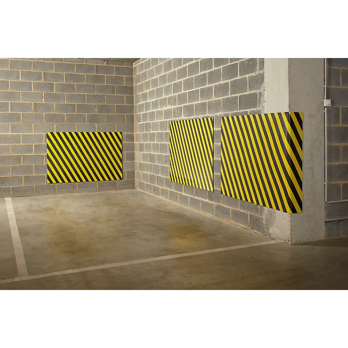 Yellow and black warning signs on gray wall. Marking in parking garage.