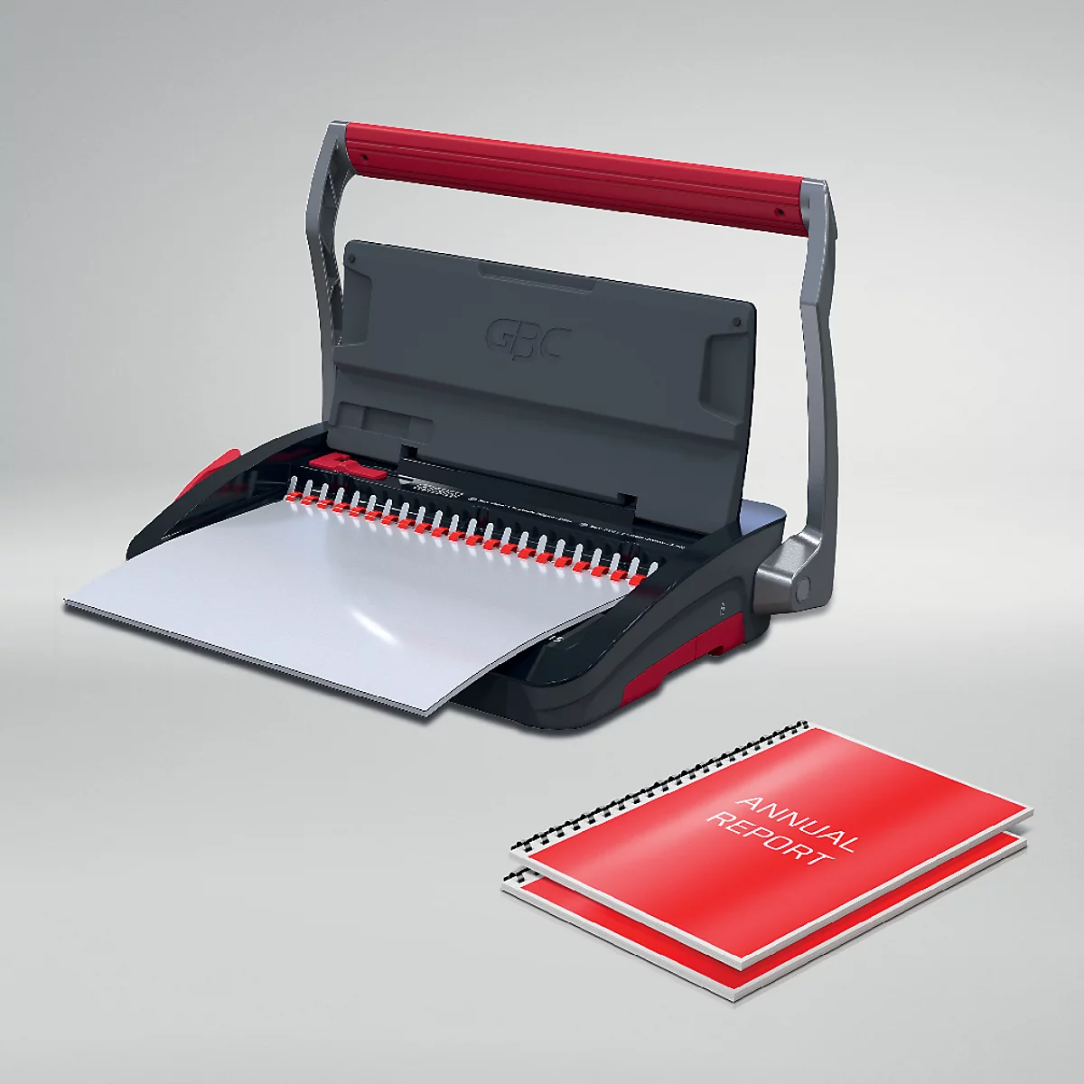Een zwarte GBC-bindmachine met rode handgreep en een rood gebonden document met de tekst "ANNUAL REPORT".