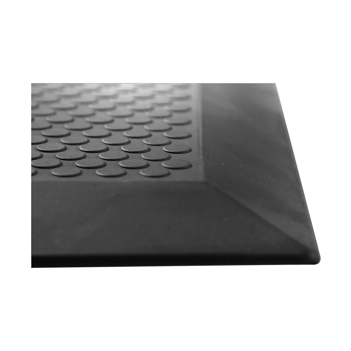 Close-up of a black rubber mat with raised round studs and beveled edges.