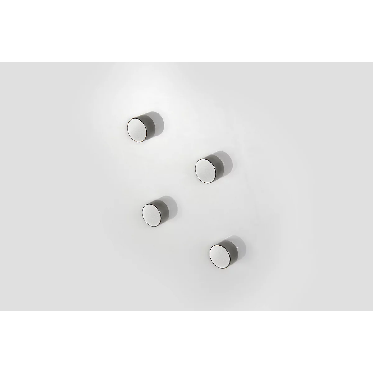 Five metallic, round objects with white surfaces and shadows, slightly offset on a white background.