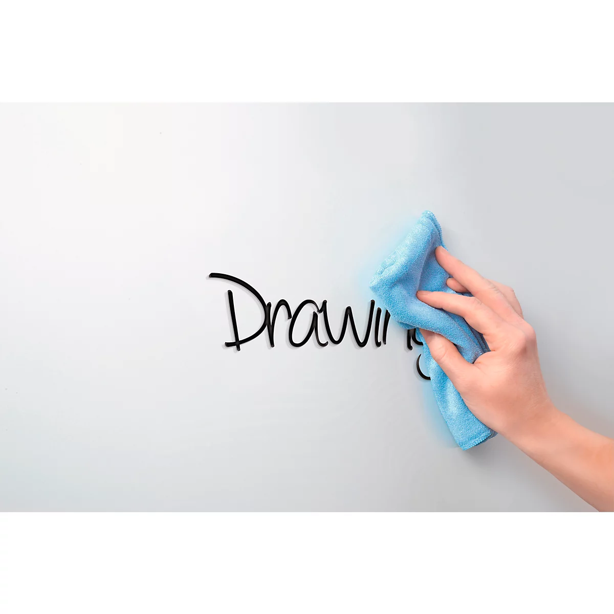 Hand wipes away "Drawing" text on white surface with blue cloth.