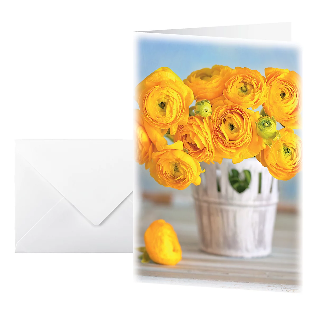 Yellow roses in a white bucket with a heart motif on a card; next to it a white envelope.