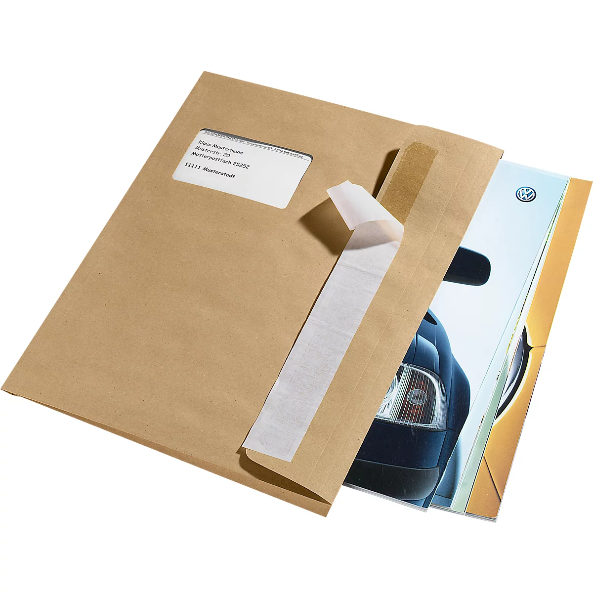 A brown envelope with a window showing an address, a VW brochure is partially visible.