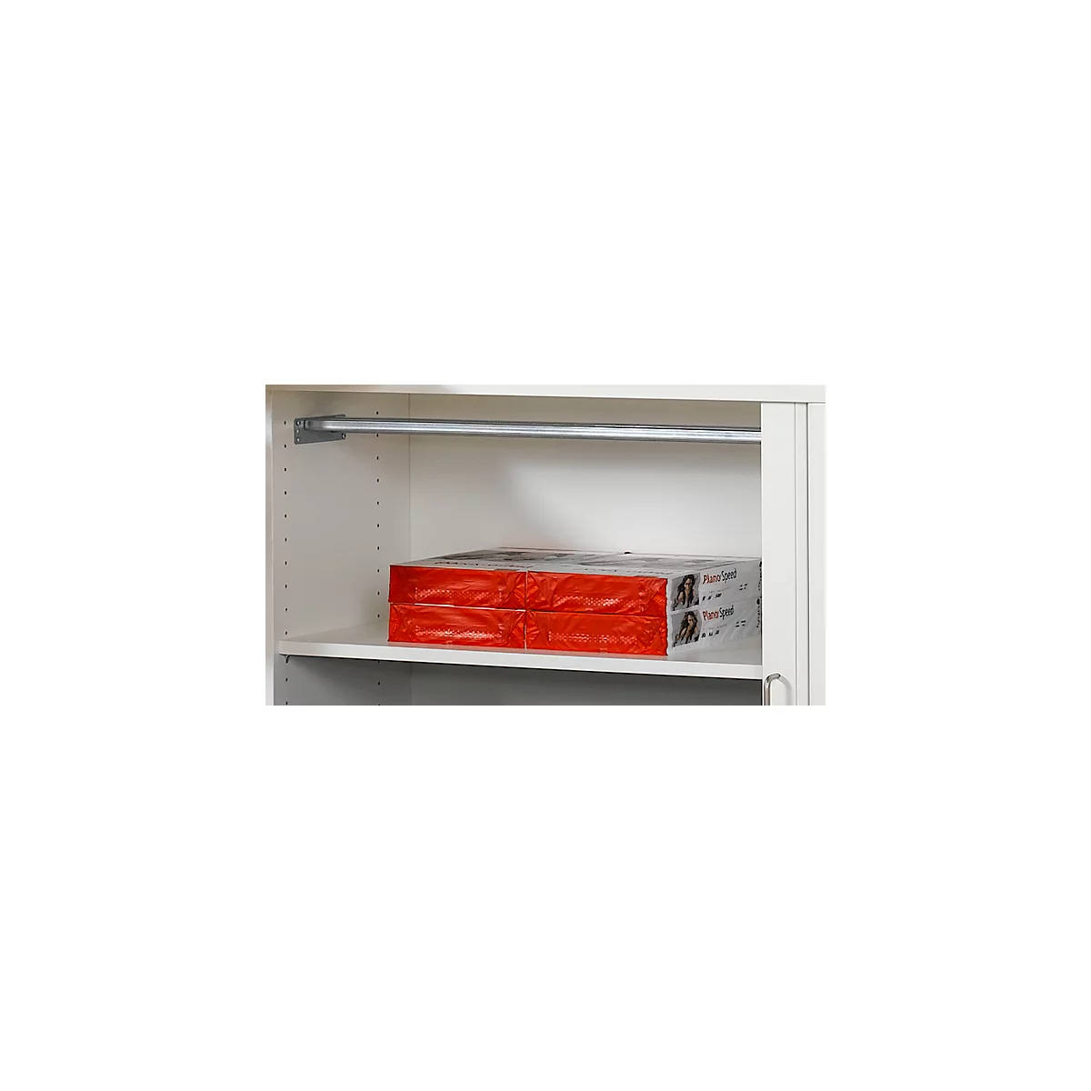 A white closet with two packs of paper. Above a clothes rail.