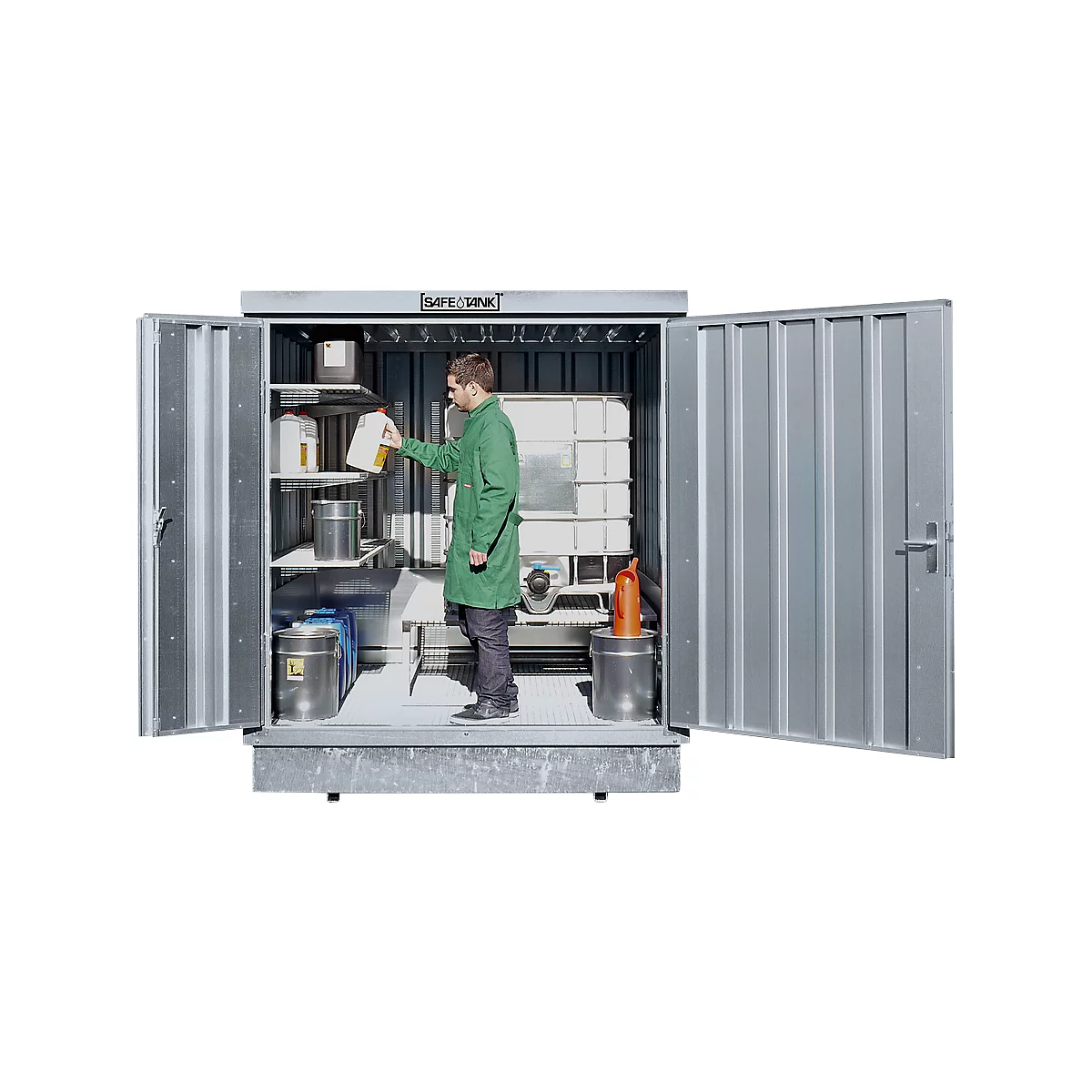 Man in green coat inside a Safe Tank. He's lifting a yellow liquid bottle. More containers and shelves are in the background.