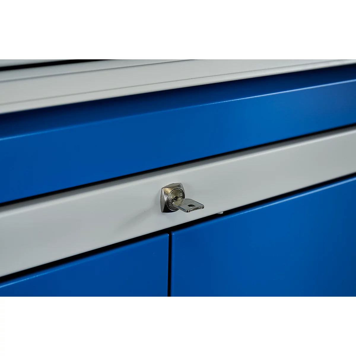 Key in lock, blue and white cabinet doors.