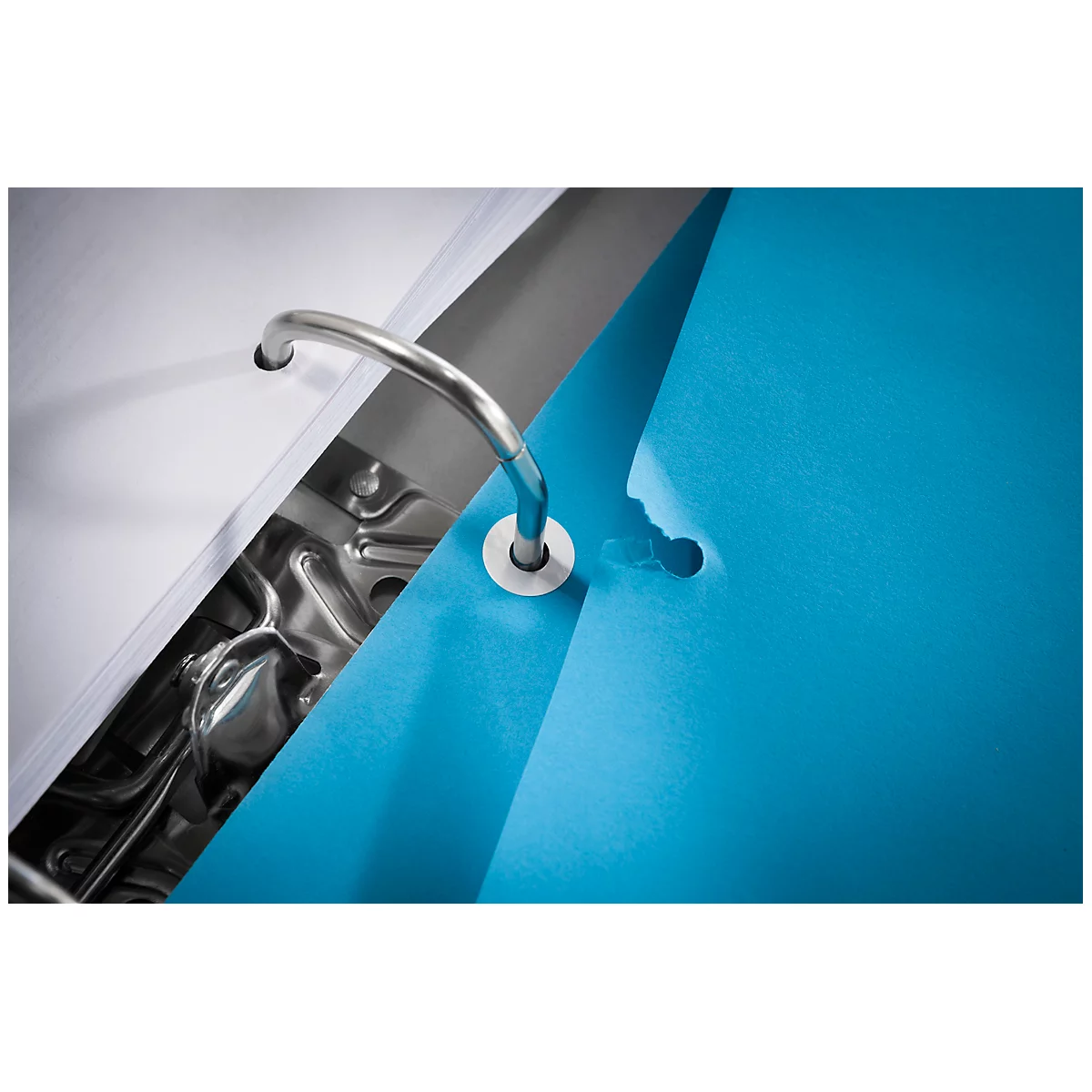 Close-up of a blue binder. The silver metal bar is open, behind it a stack of paper. The right side of the binder can be seen.