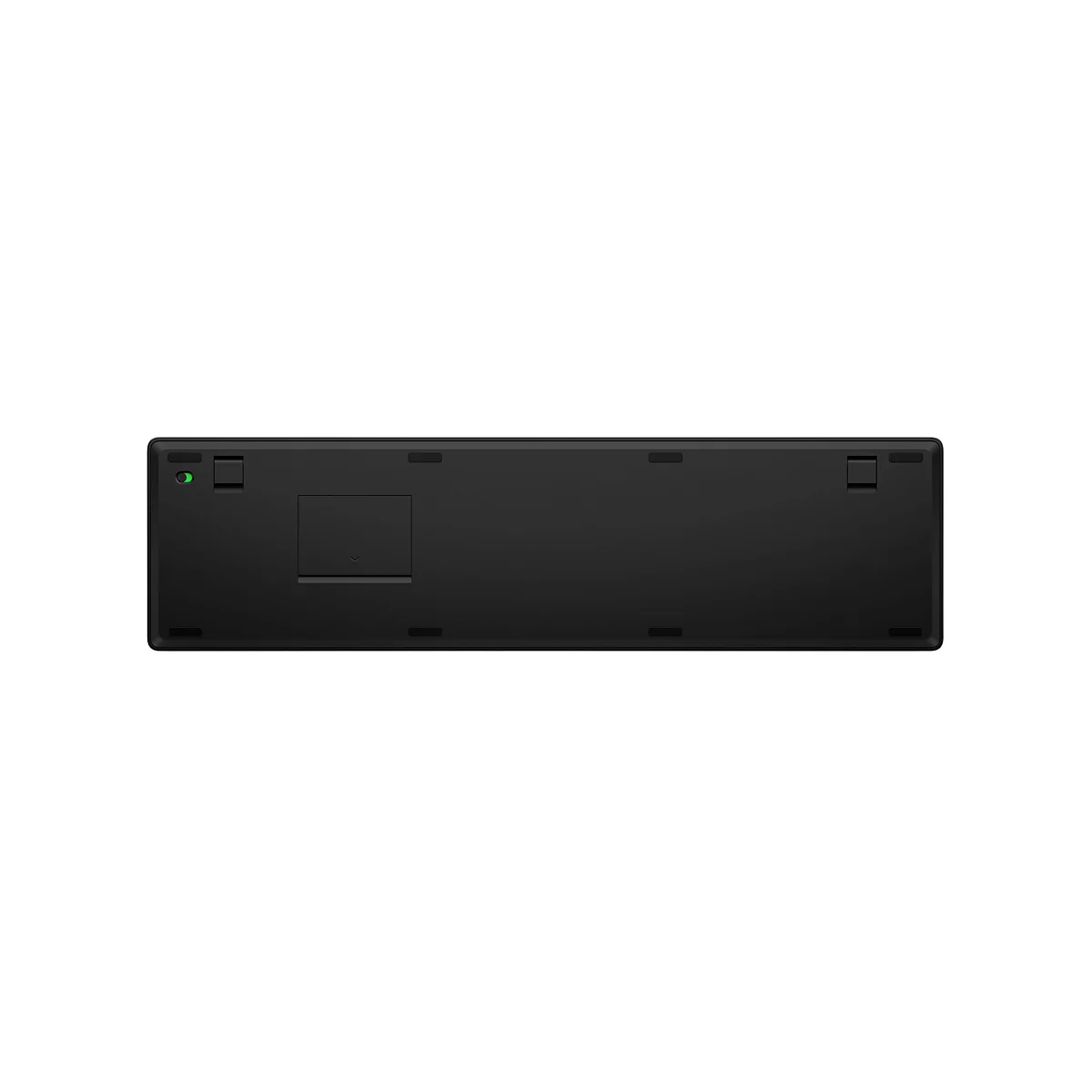 Unterseite einer schwarzen Tastatur mit Batteriefach und grünem Schiebeschalter.