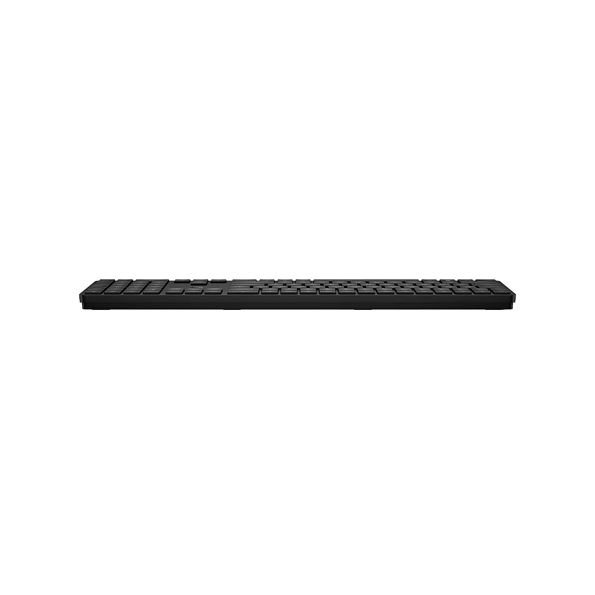 Flache, schwarze kabellose Tastatur in der Seitenansicht vor weißem Hintergrund.