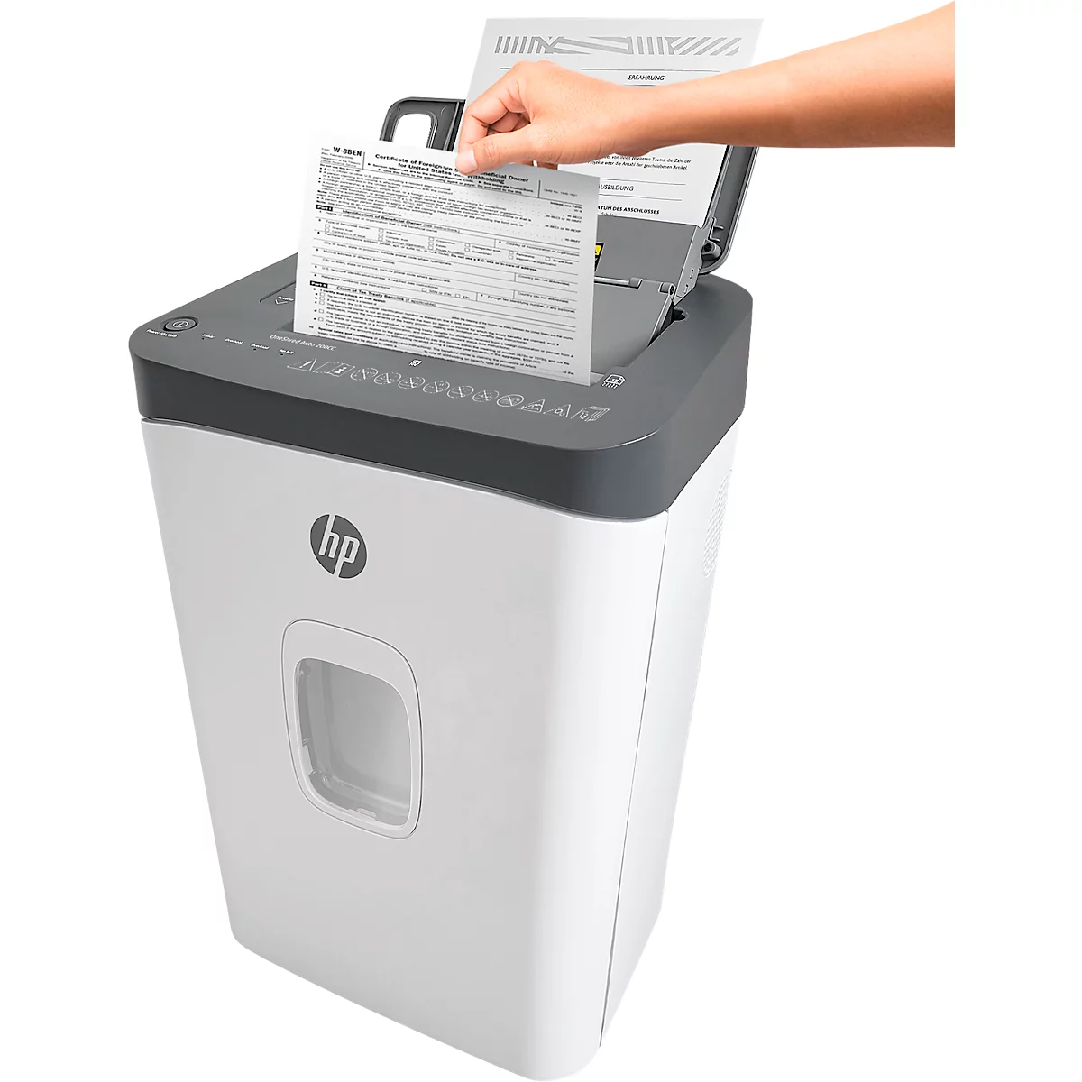 A hand inserting paper into a white HP shredder. The device has a gray top and the HP logo.