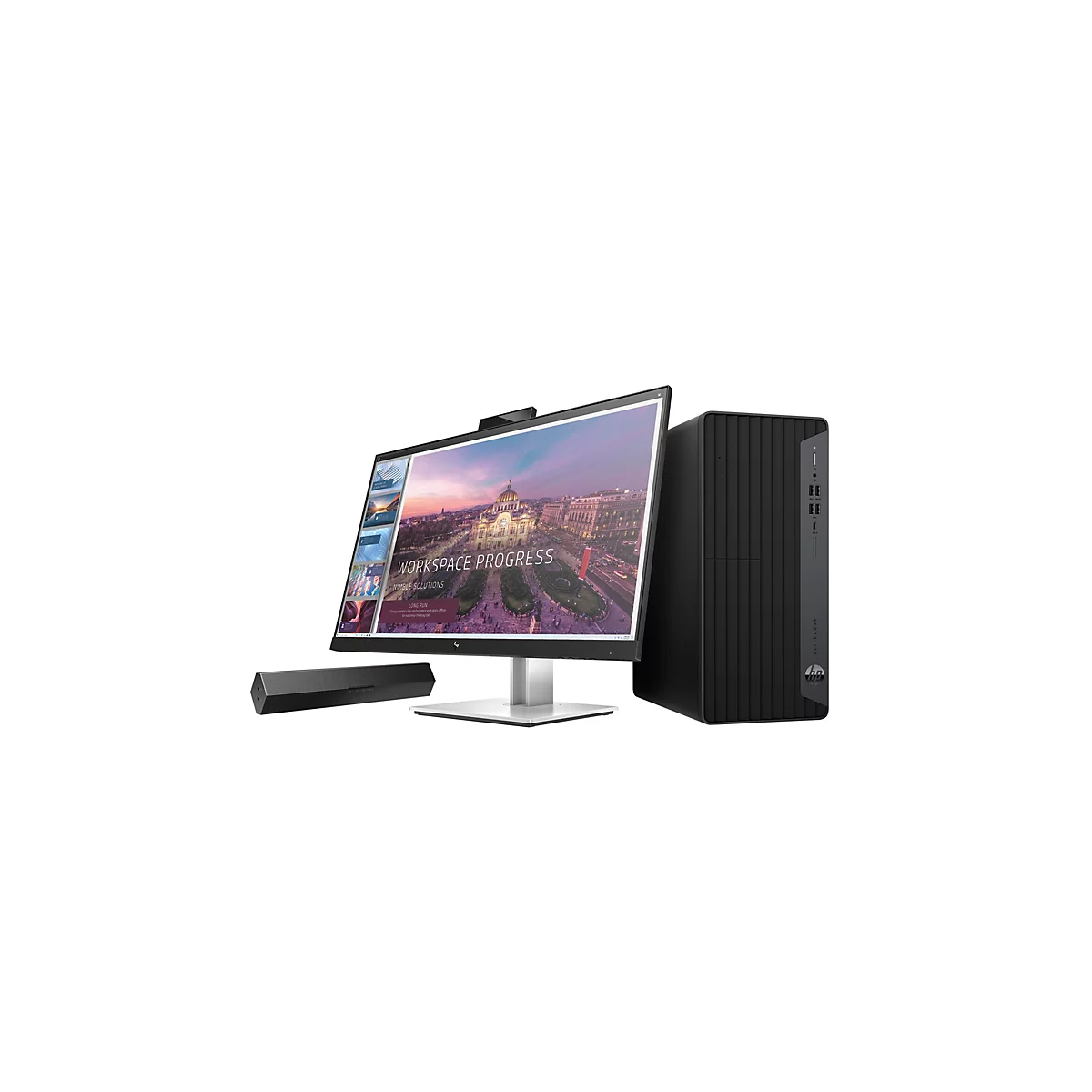 Ein Computer-Setup mit Monitor, Lautsprecher und Tower-PC. Auf dem Monitor ist der Schriftzug "WORKSPACE PROGRESS" zu sehen.