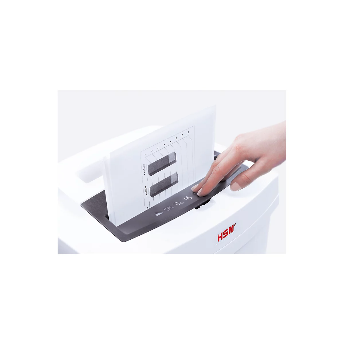 Hand presses button on shredder. A sheet with a diagram is being shredded. Logo: HSM.