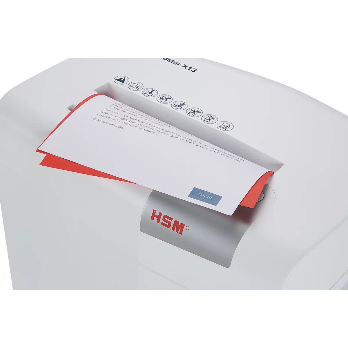 A white paper shredder is shredding a document that is partially visible. Red edge and blue text on the paper.
