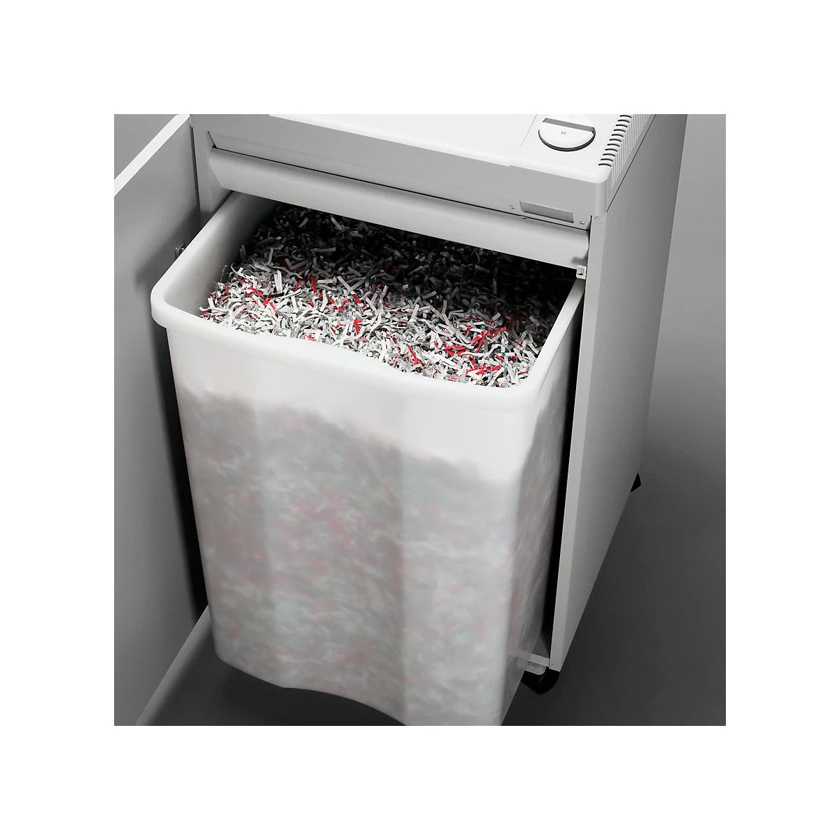 A paper shredder with a bin full of shredded paper.