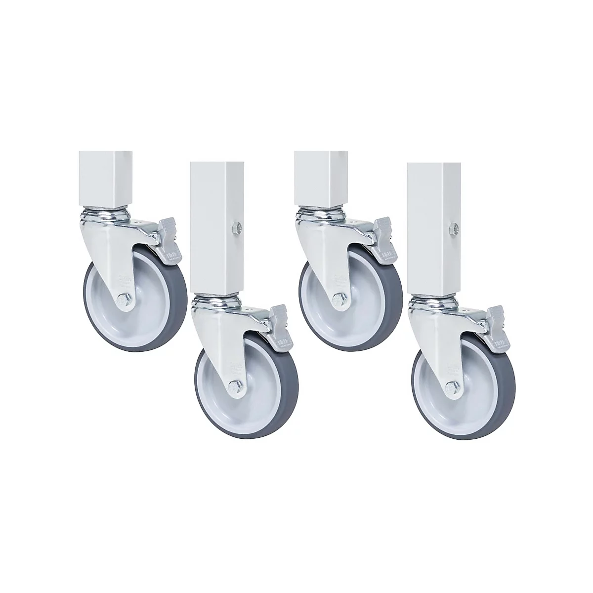 Gros plan de quatre roulettes. Roues grises, cadres gris, supports peints en blanc avec leviers de verrouillage.