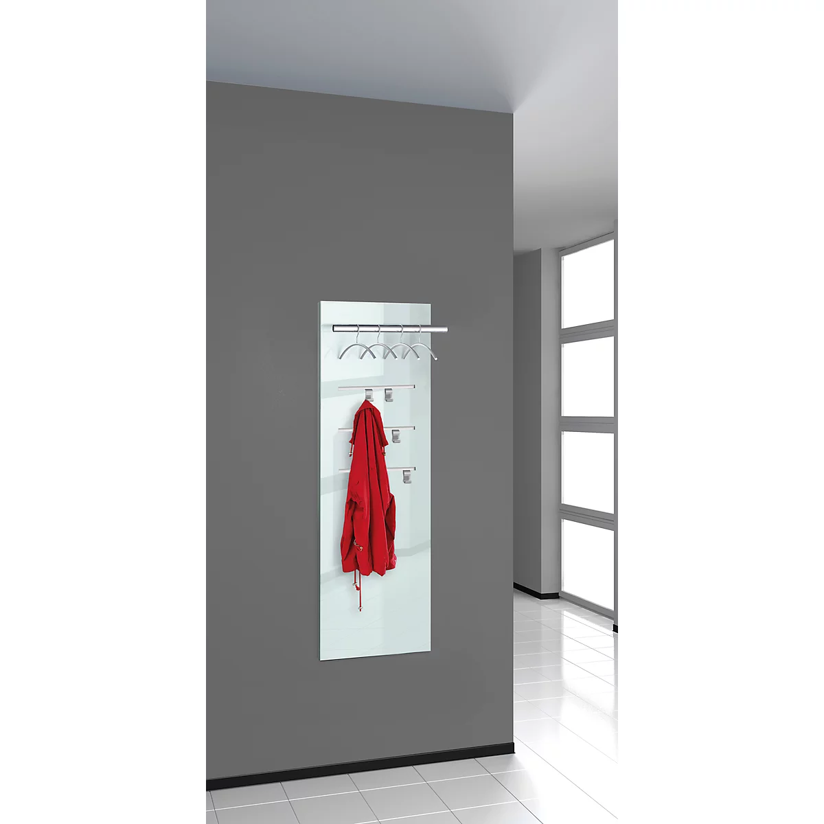 White coat rack on gray wall with red jacket, hooks and hangers. Bright, modern design.