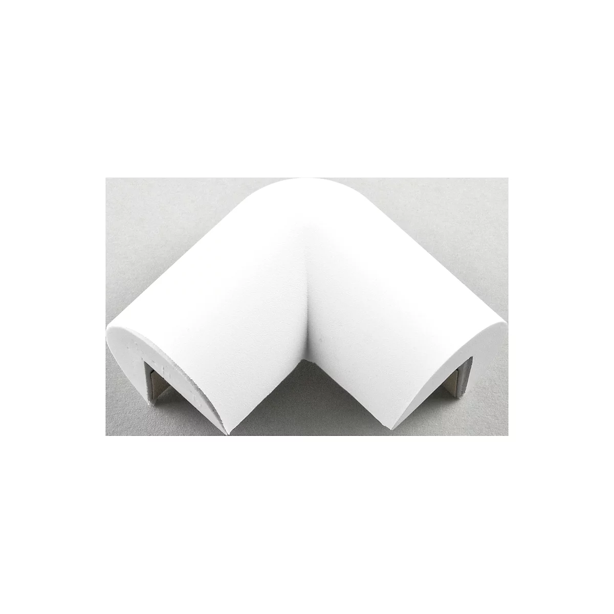 A white corner protector made of foam, fitted with metal clips, against a gray background.