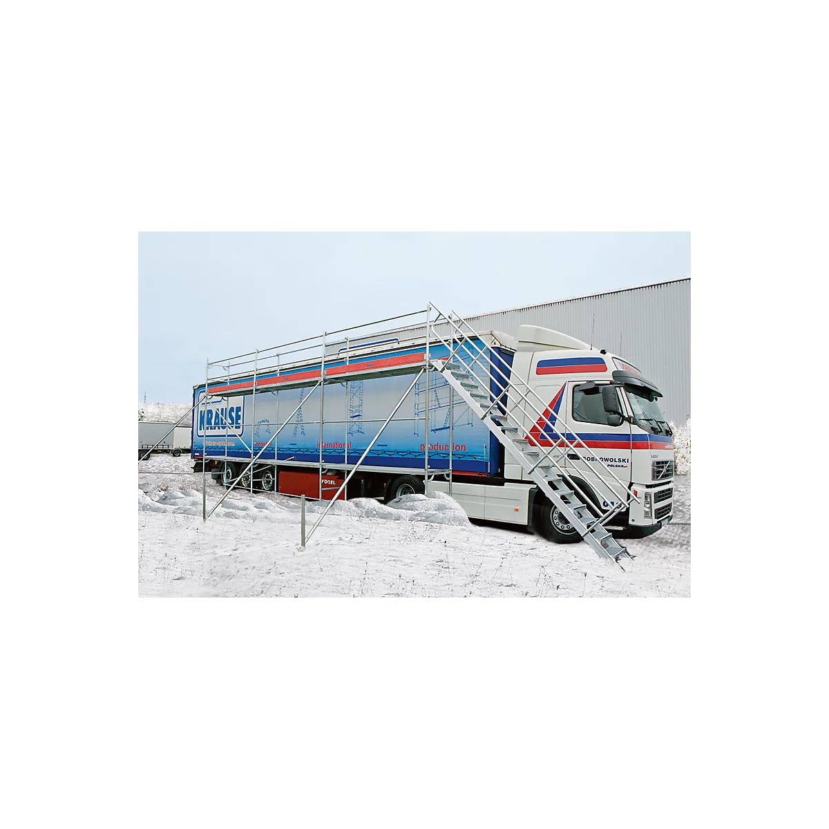 Truck with scaffolding and stairs in the snow. Inscription: KRAUSE. The picture shows the product in use.