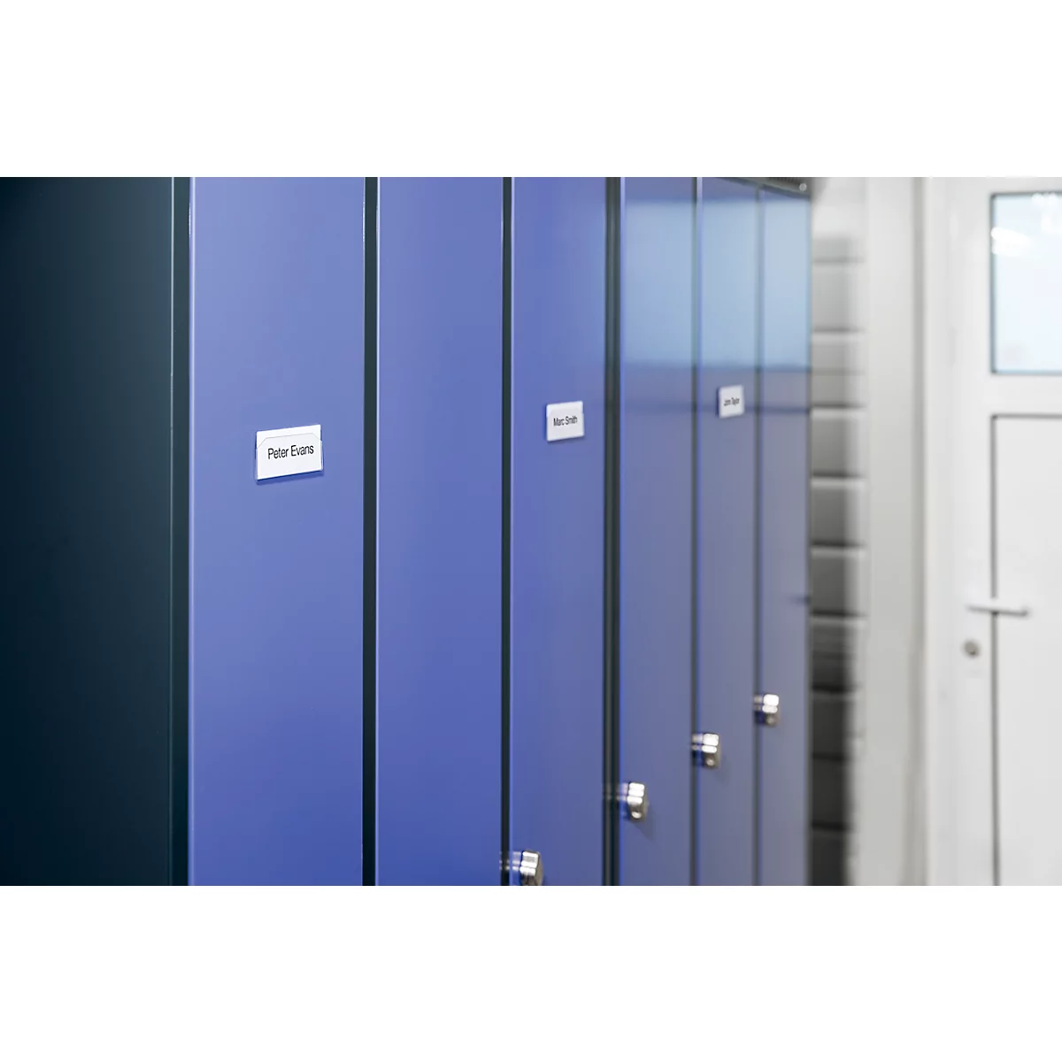 Row of blue lockers with names on some. A door is visible in the background.