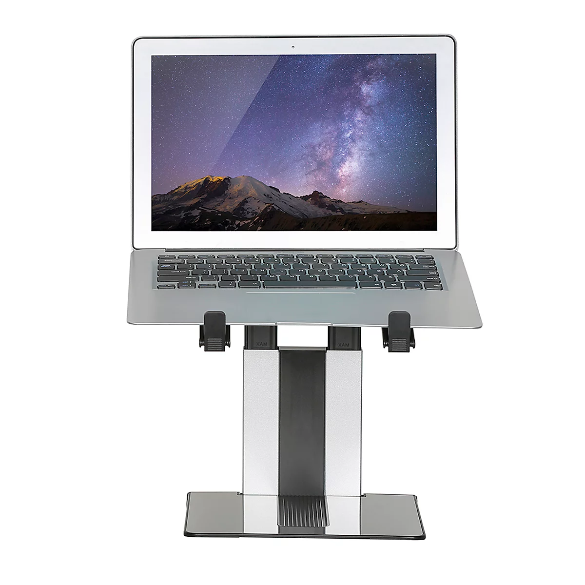 A laptop rests on a silver stand. The display shows a mountain landscape with a night sky.