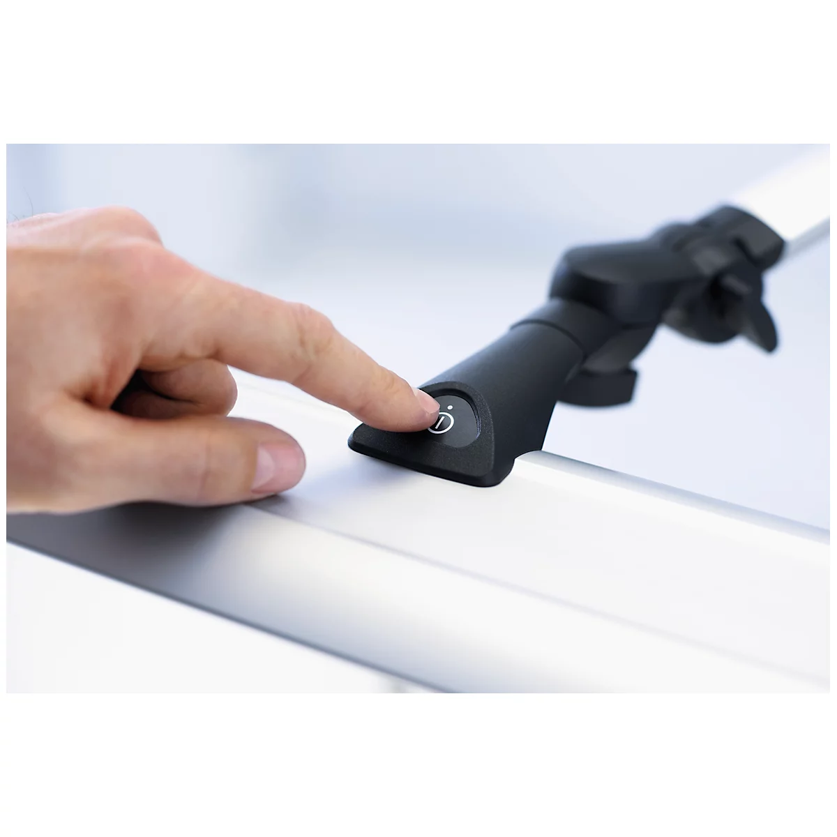 Finger pressing button with light symbol. Black control element on silver background.