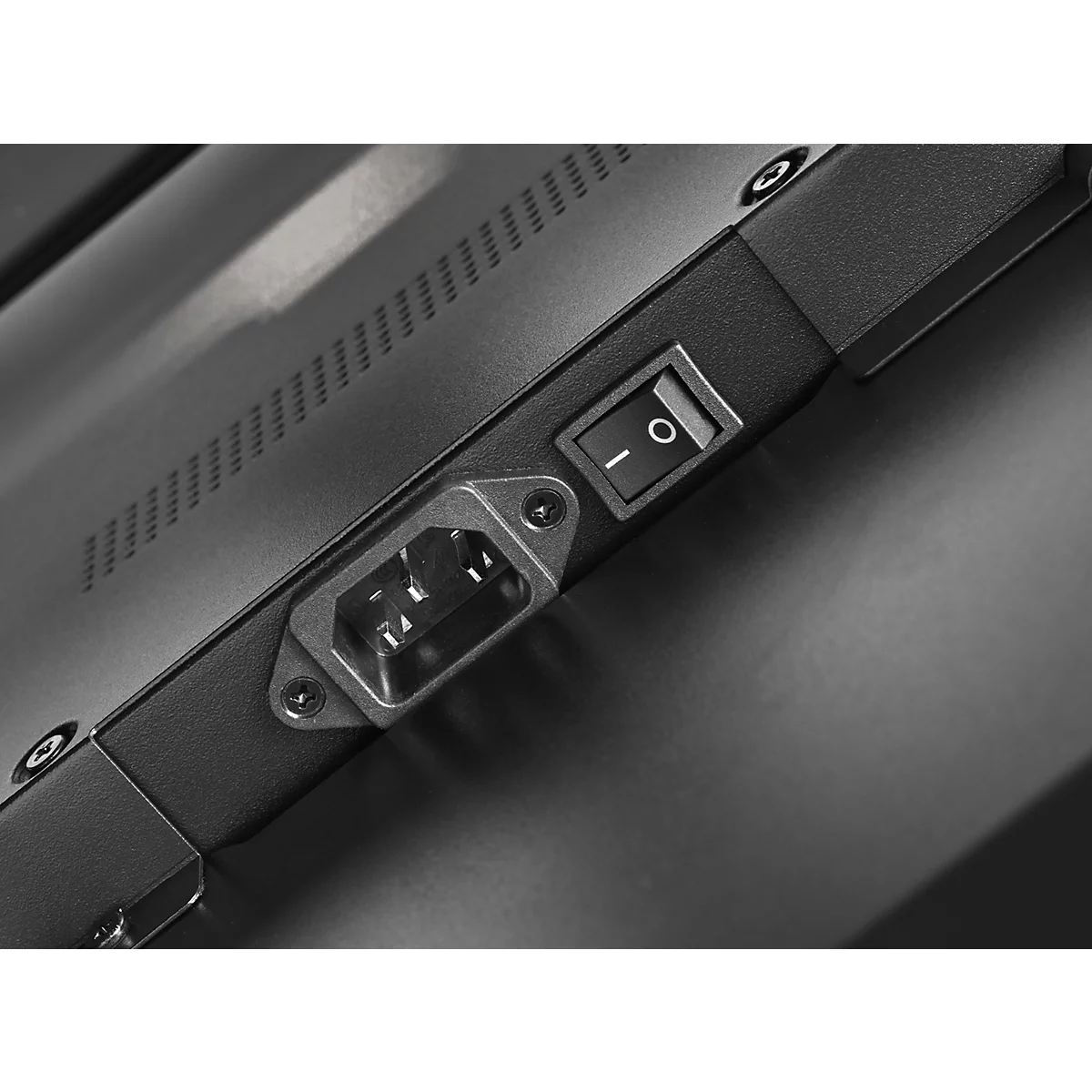 Close-up: stroomaansluiting, aan/uit-schakelaar met symbool, donker oppervlak met ventilatiesleuven.