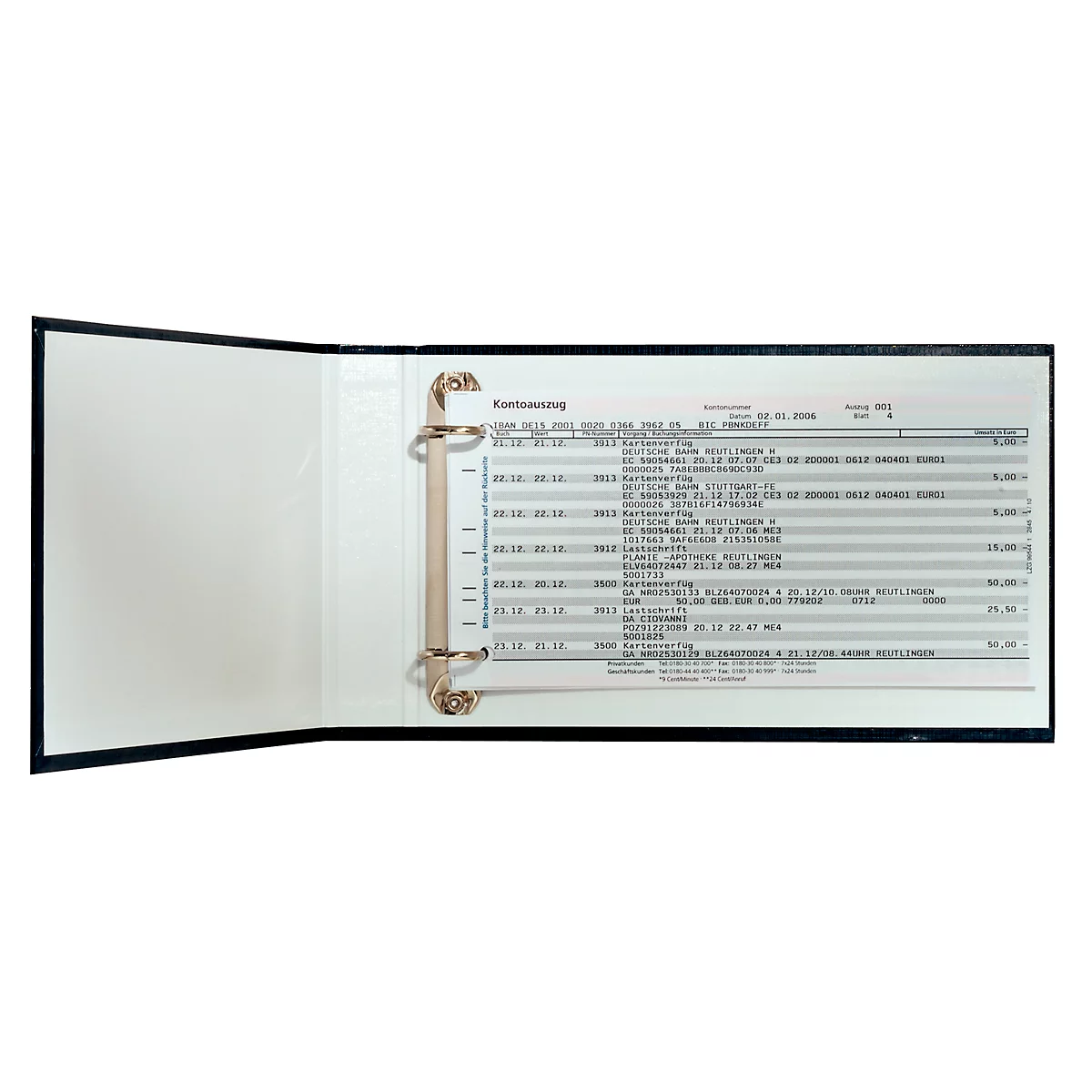 An open black binder with a sheet of paper containing tables and text. The binder has gold-colored metal rings.