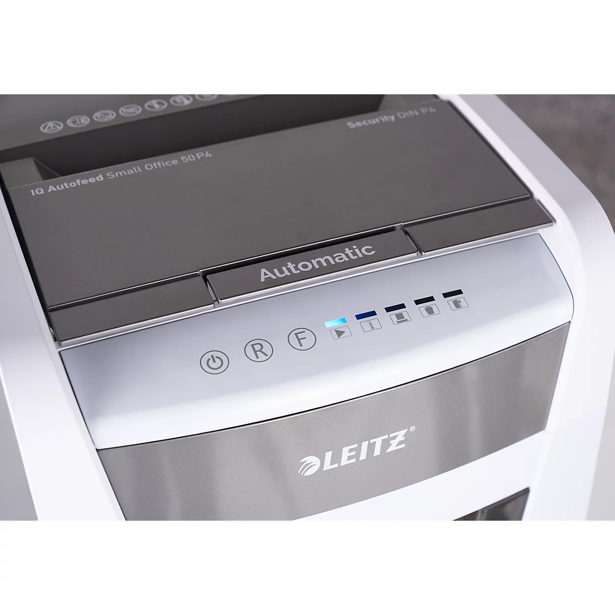 Close-up of a white paper shredder. The control panel is labeled and lit up. The Leitz logo is visible.