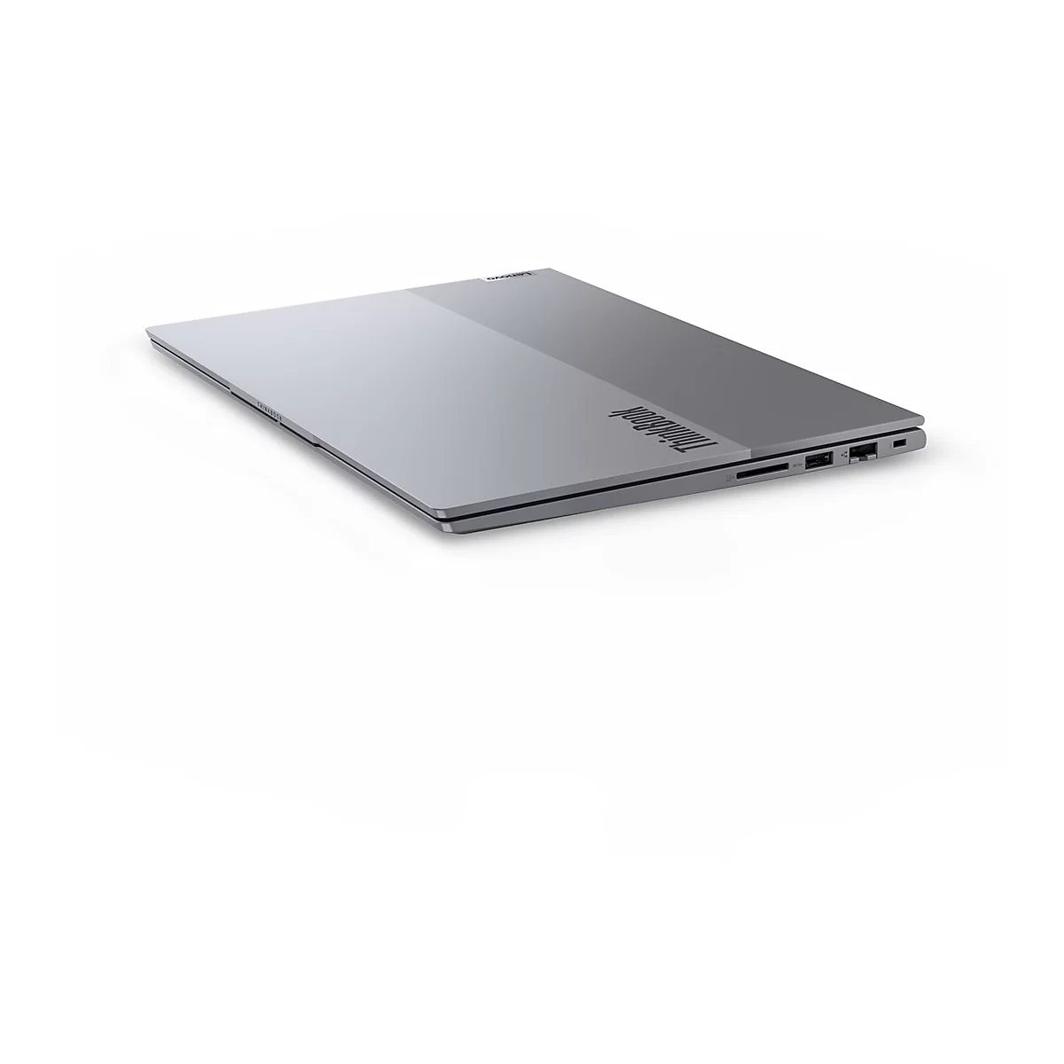 Ein silberner Laptop liegt schrÃ¤g auf weiÃŸem Hintergrund. Das Thinkpad-Logo ist erkennbar.