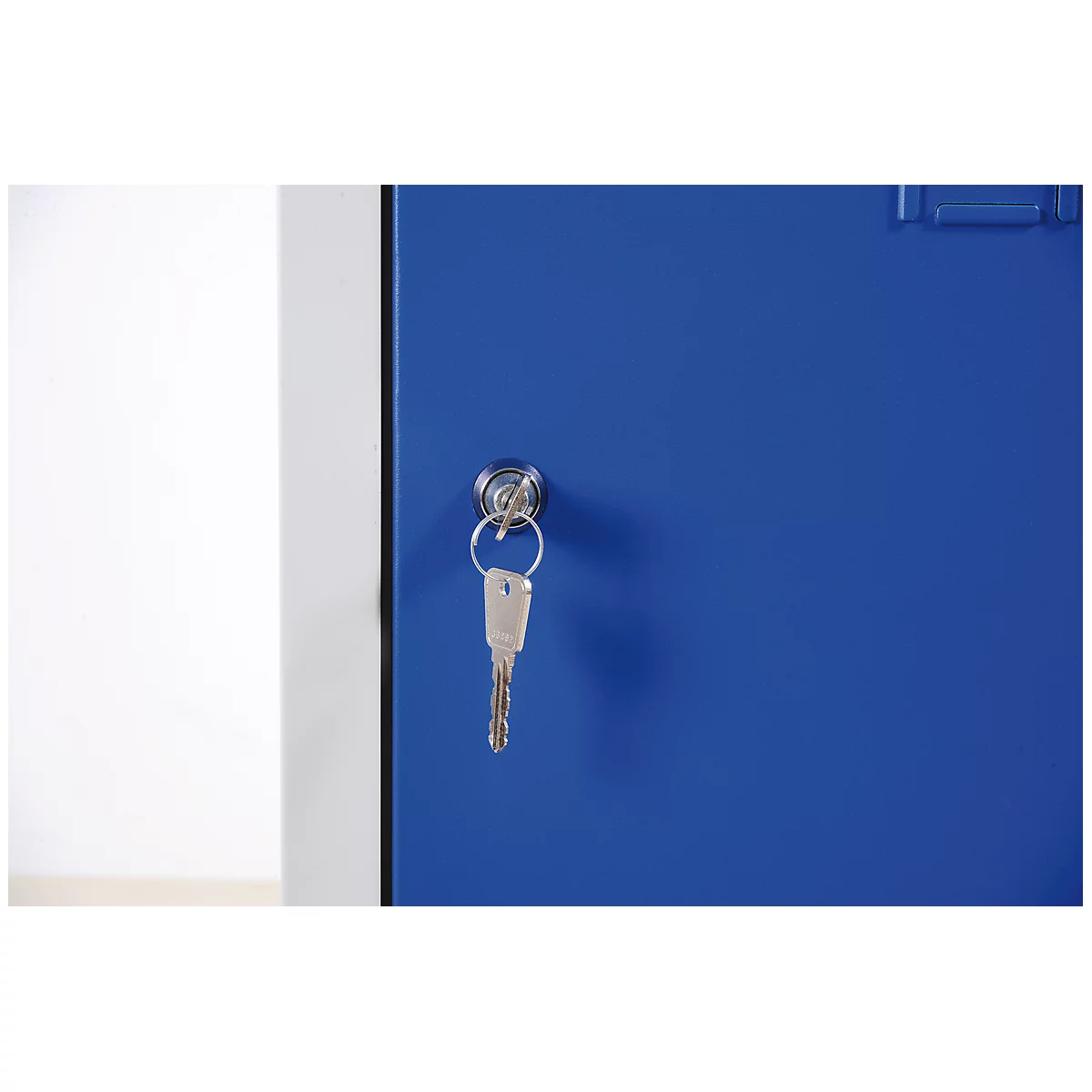 Close-up of a blue locker with key in the lock.