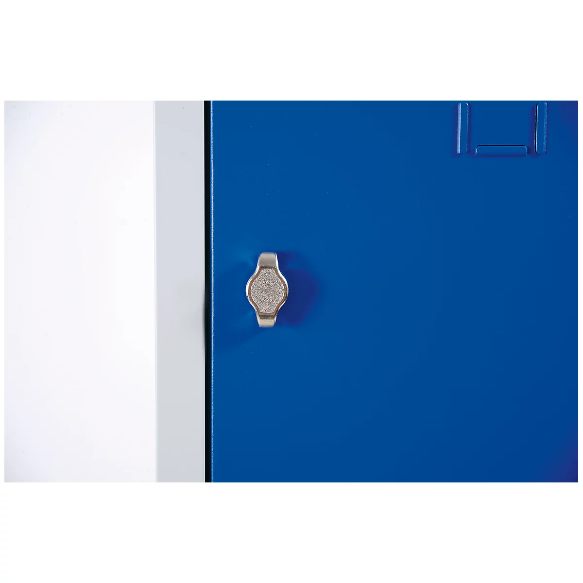 Detail shot of a blue cabinet with a silver handle. The door is on the right, a white wall on the left.