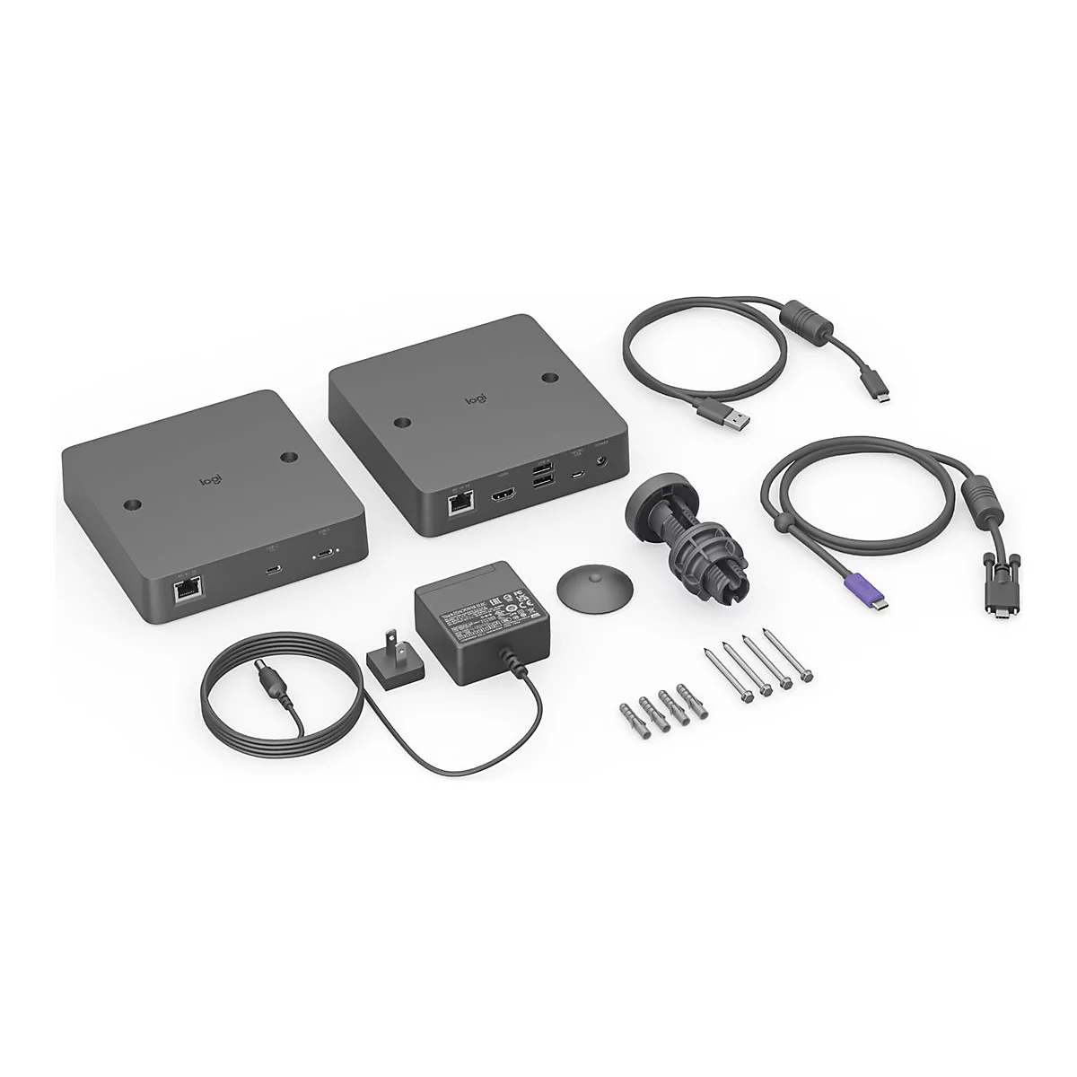 Graue Videokonferenz-Hardware mit Kabeln, Netzteil und Befestigungsmaterial auf weißem Grund.
