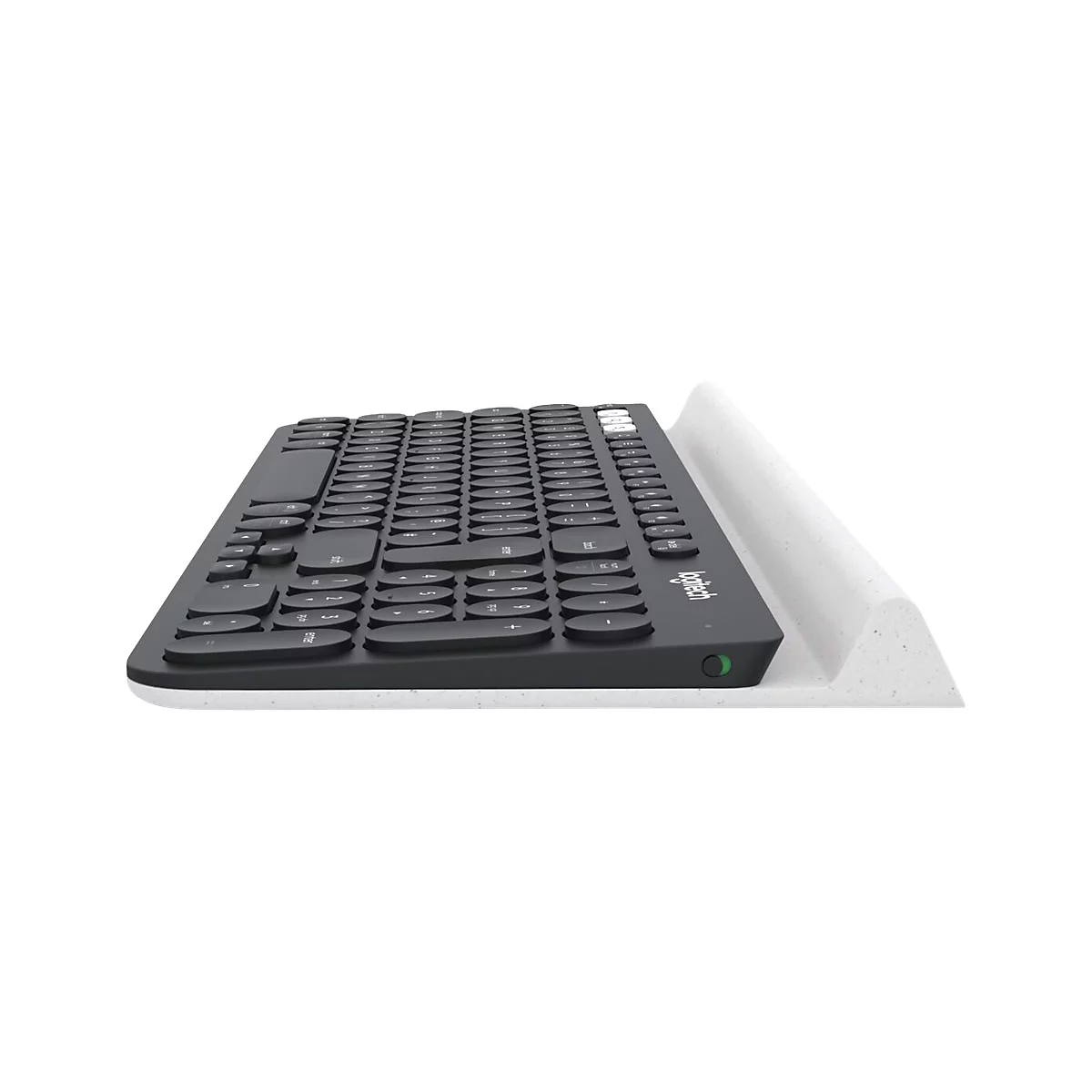 Draufsicht auf eine schwarze Tastatur, die auf einer weißen Ablage liegt.