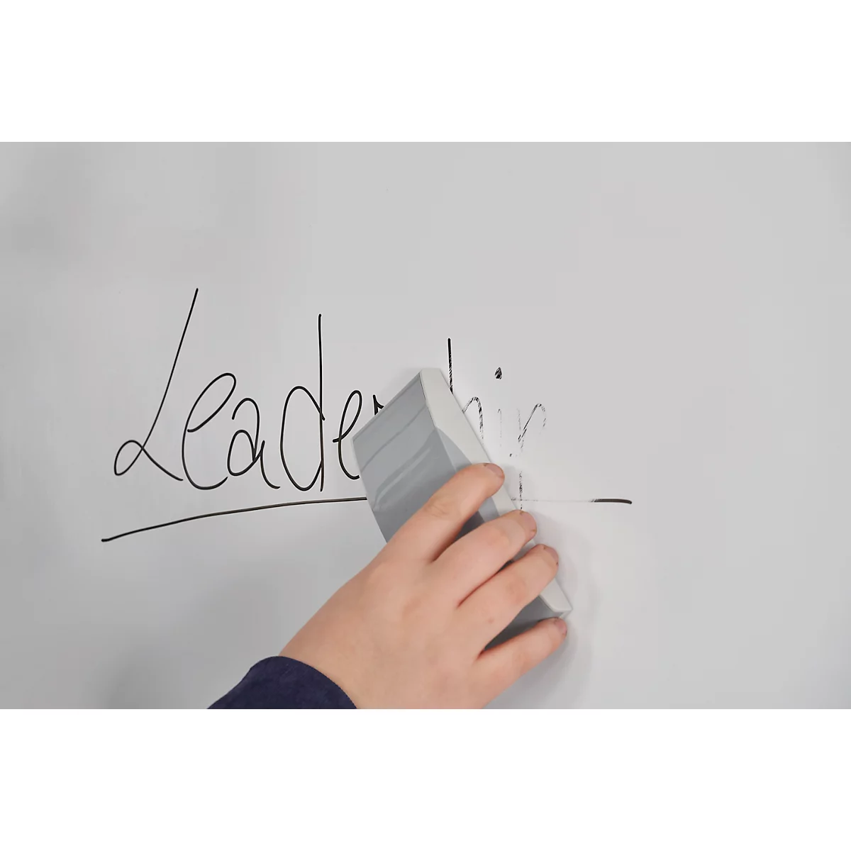 Ein Arm wischt das Wort "Leadership" von einer weißen Tafel. Nur "Lead" ist noch lesbar.