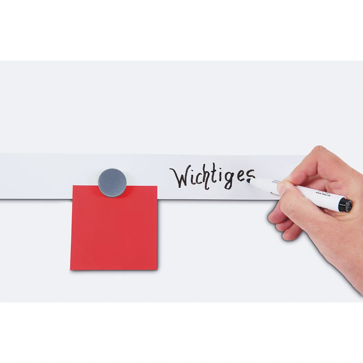 Hand writing "Important" on a whiteboard with a white pen. Red note with magnet.