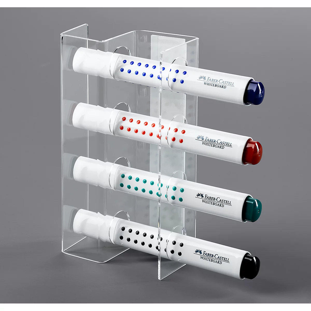Four Faber-Castell whiteboard markers in a transparent holder. Pens in blue, red, green and black.