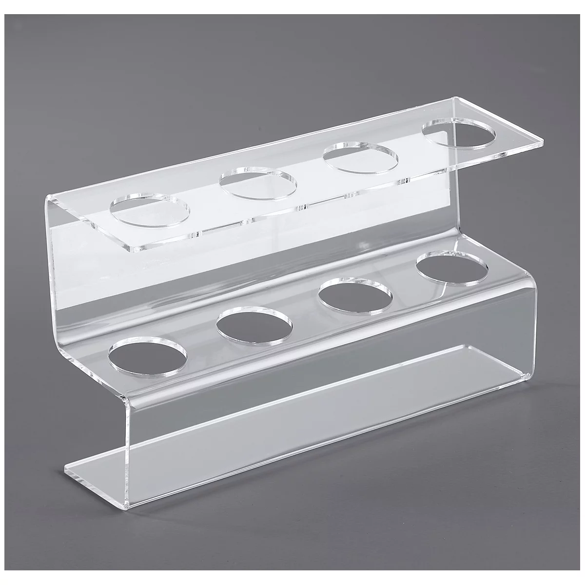 Transparent acrylic pen holder with two levels, each with four holes. On a gray background.